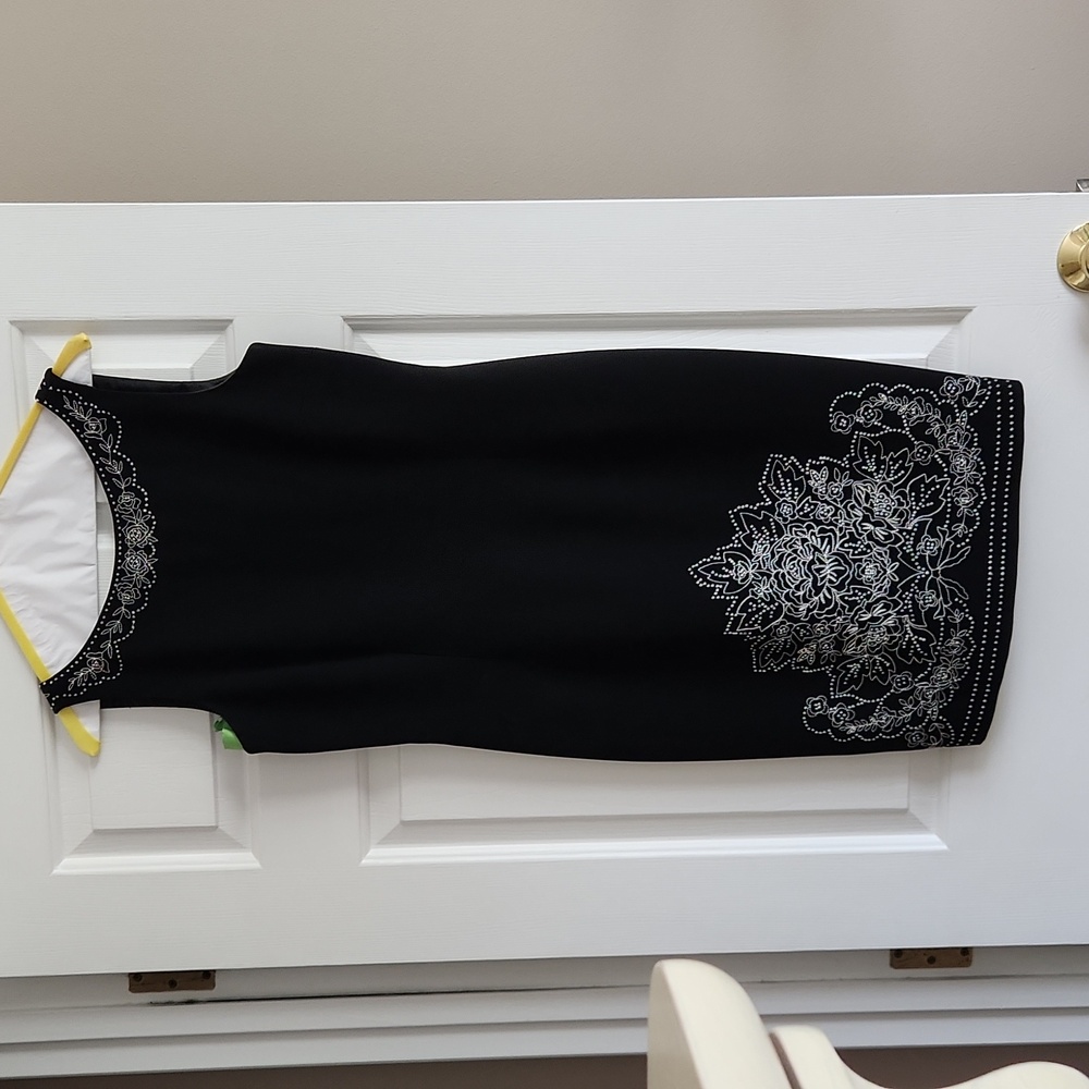 Maggy London little black dress embellished with bead-like stitching.